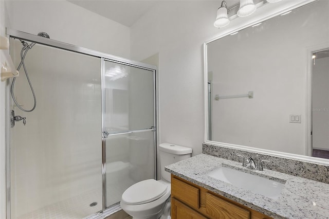 bathroom with vanity, toilet, and walk in shower