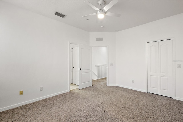 unfurnished bedroom featuring ceiling fan, a closet, and carpet floors