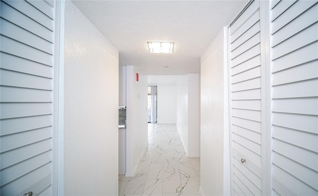 corridor with a textured ceiling