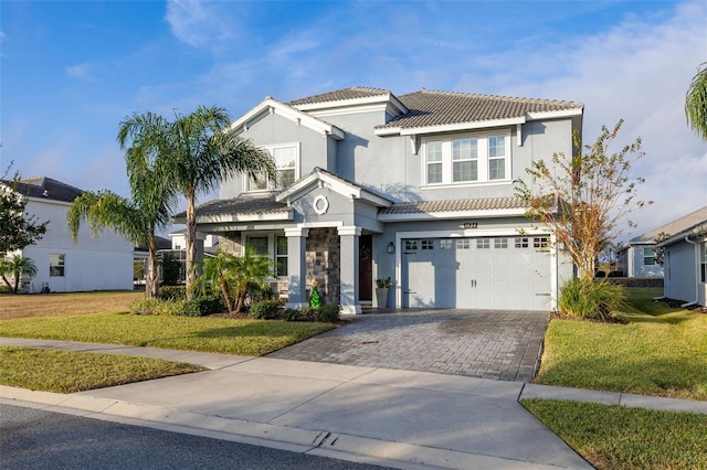 view of front of property featuring a front yard and a garage