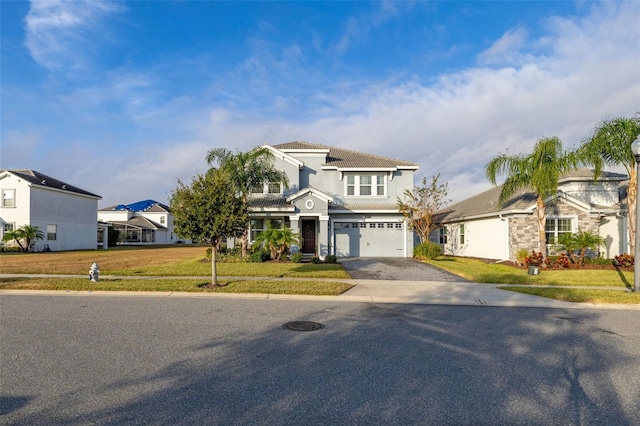 view of front of home featuring a front yard and a garage