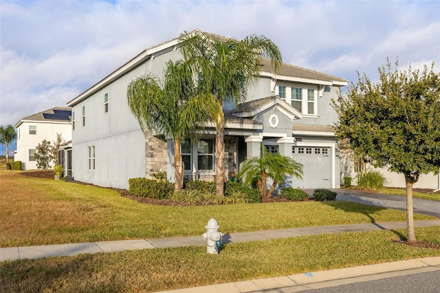 view of front of property with a garage and a front lawn