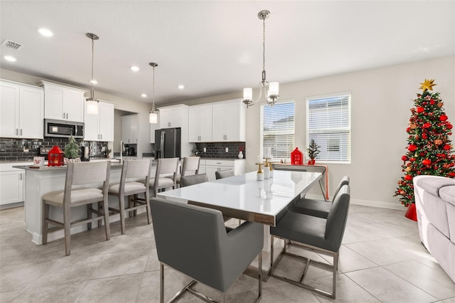 dining space featuring a notable chandelier and light tile patterned floors