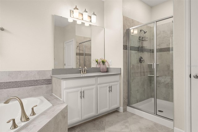 bathroom featuring tile patterned flooring, vanity, and separate shower and tub