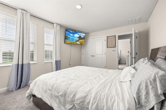 carpeted bedroom with a closet