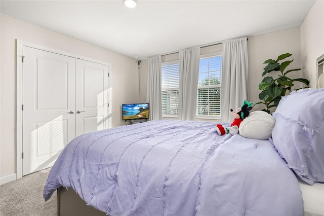 carpeted bedroom featuring a closet