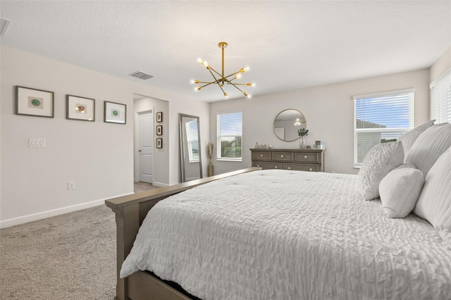 bedroom with carpet and a notable chandelier