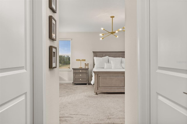 carpeted bedroom with an inviting chandelier