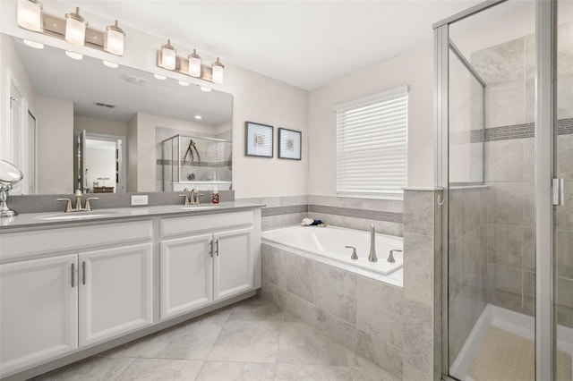 bathroom with tile patterned floors, vanity, and plus walk in shower