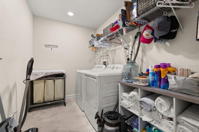 clothes washing area featuring washer and dryer and tile patterned floors