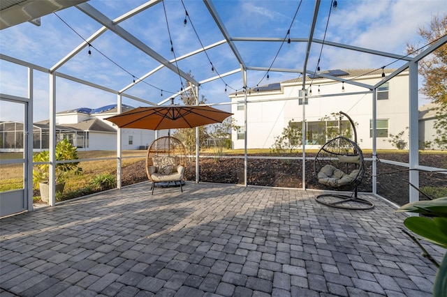 view of patio featuring a lanai