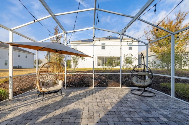 view of patio / terrace featuring glass enclosure