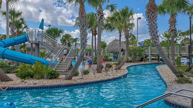 view of swimming pool with a water slide