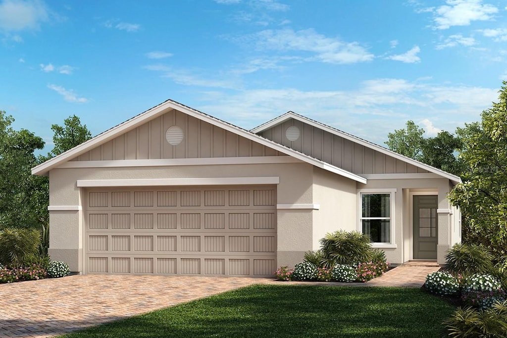 ranch-style house featuring a front yard and a garage