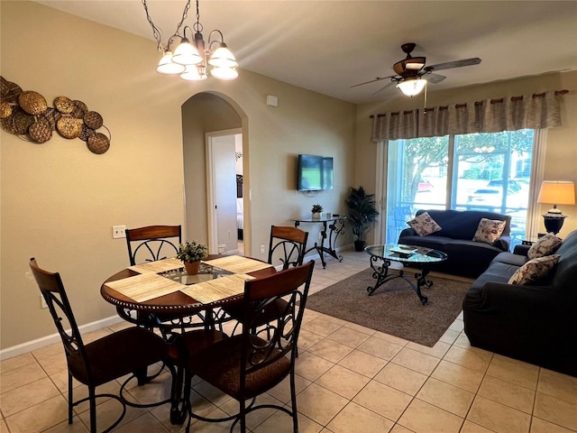 dining space featuring ceiling fan with notable chandelier and light tile patterned flooring