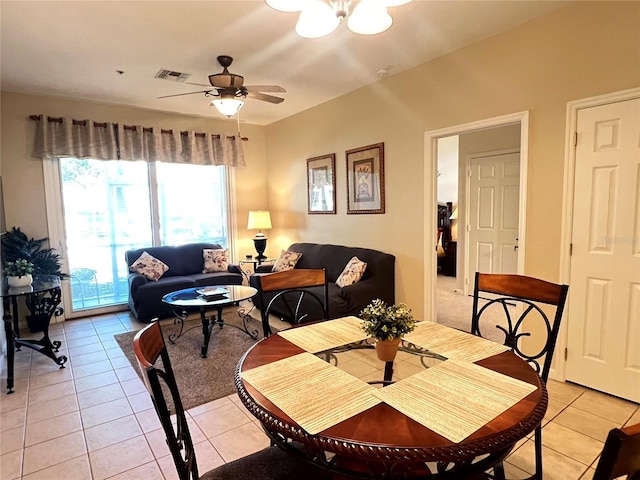 tiled dining room with ceiling fan