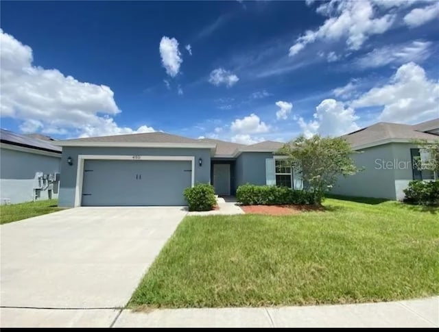 ranch-style house with a garage and a front lawn