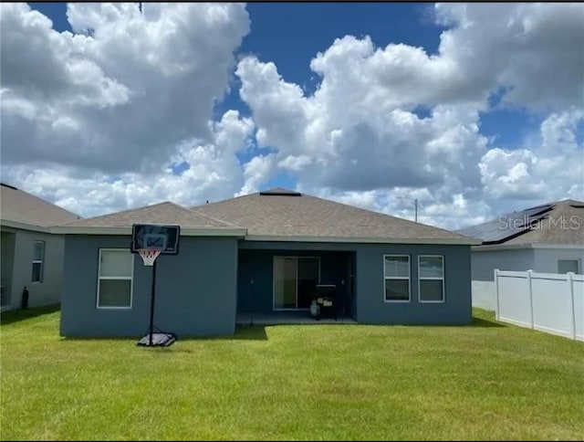 rear view of house with a yard