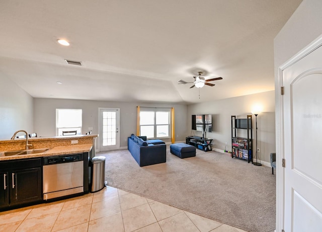 kitchen featuring ceiling fan, dishwasher, sink, light colored carpet, and lofted ceiling