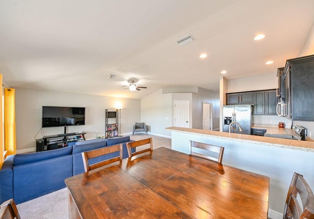 dining area with ceiling fan and sink