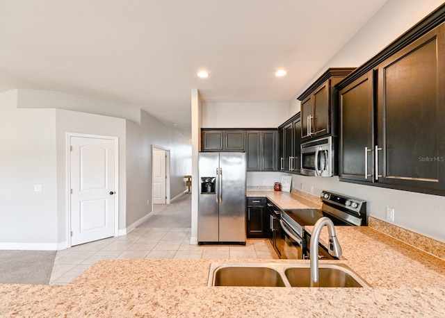 14308 Edinburgh Moor Dr, Wimauma, FL 33598 - kitchen with stainless steel appliances, light tile patterned flooring, and recessed lighting