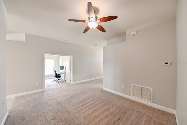 empty room featuring light colored carpet and ceiling fan