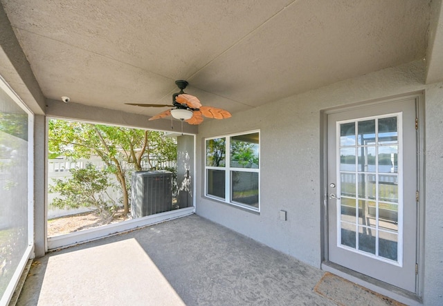 unfurnished sunroom featuring a wealth of natural light and ceiling fan