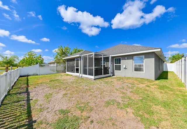 14308 Edinburgh Moor Dr, Wimauma, FL 33598 - back of property featuring a sunroom, a fenced backyard, and stucco siding