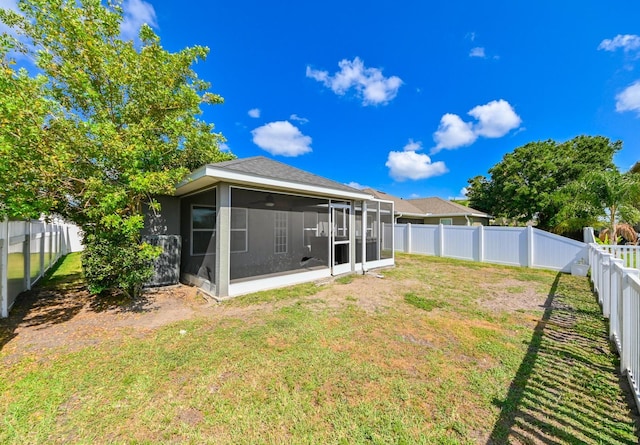 14308 Edinburgh Moor Dr, Wimauma, FL 33598 - back of property featuring a sunroom and a fenced backyard