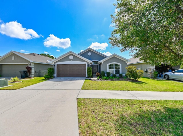 ranch-style home with a garage and a front lawn