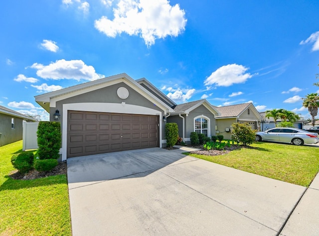 14308 Edinburgh Moor Dr, Wimauma, FL 33598 - single story home featuring stucco siding, a garage, a front yard, and driveway