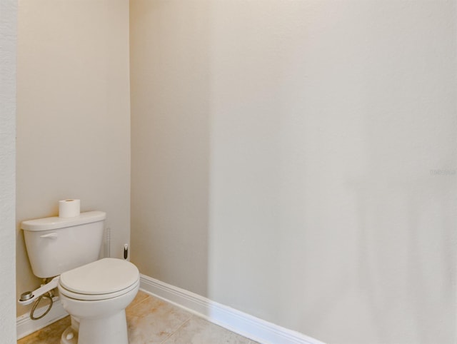 bathroom with tile patterned flooring and toilet