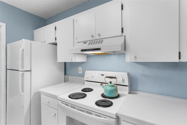 kitchen featuring white cabinets and white appliances