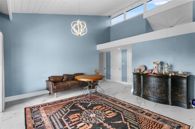 living room with a chandelier and high vaulted ceiling