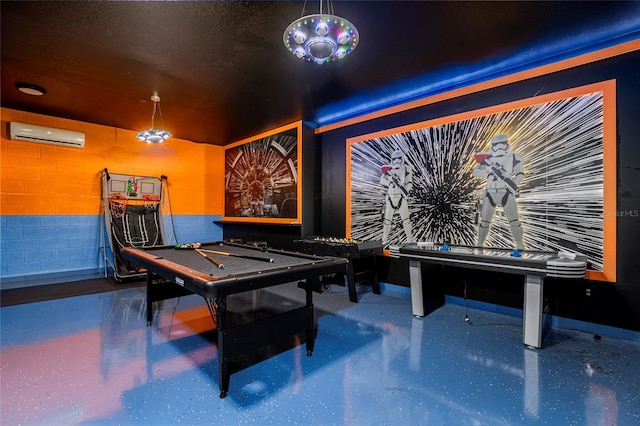 game room with an AC wall unit, a textured ceiling, and pool table