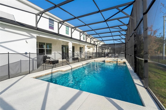 view of pool featuring glass enclosure and a patio