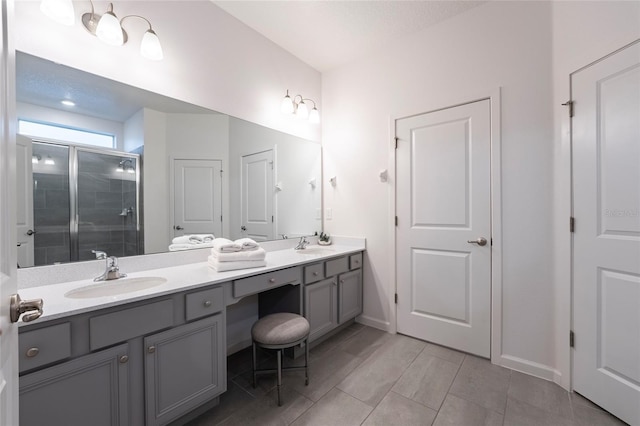 bathroom with tile patterned floors, vanity, and an enclosed shower