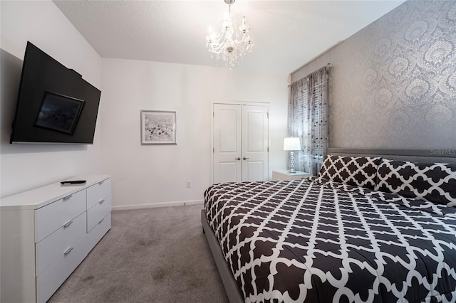 bedroom featuring carpet, a textured ceiling, a chandelier, and a closet