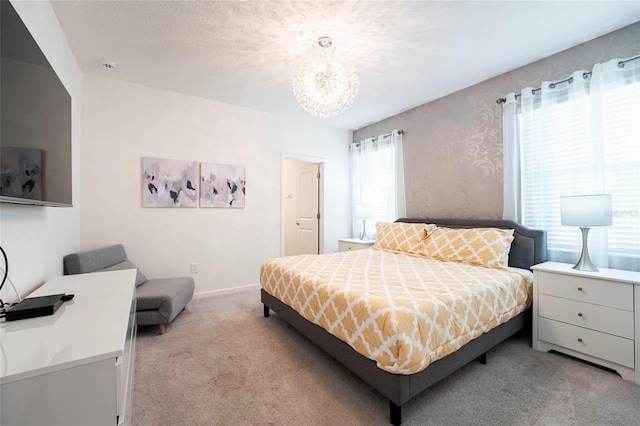 bedroom with light colored carpet and an inviting chandelier