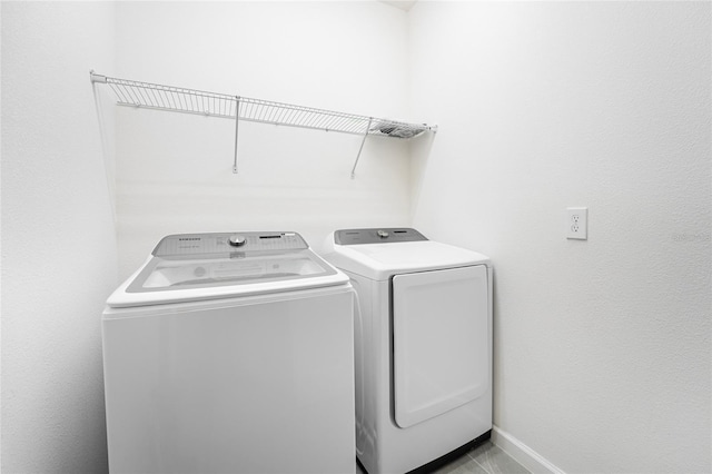 clothes washing area featuring independent washer and dryer