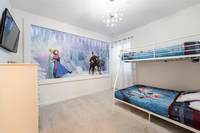 bedroom with a notable chandelier, carpet floors, and a textured ceiling