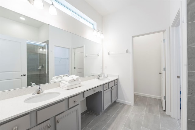 bathroom with tile patterned flooring, vanity, and a shower with shower door