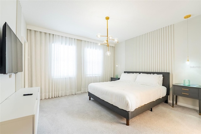 bedroom with light colored carpet and a notable chandelier