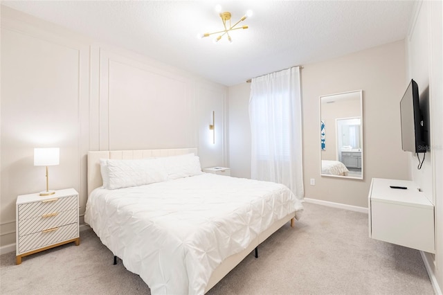 carpeted bedroom with a textured ceiling and an inviting chandelier