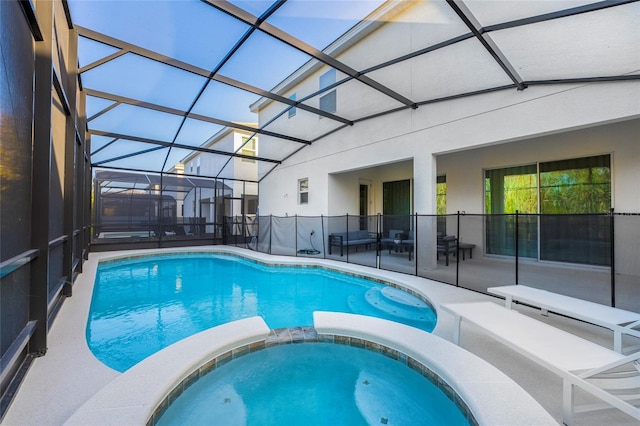 view of pool featuring an in ground hot tub, a patio, and glass enclosure