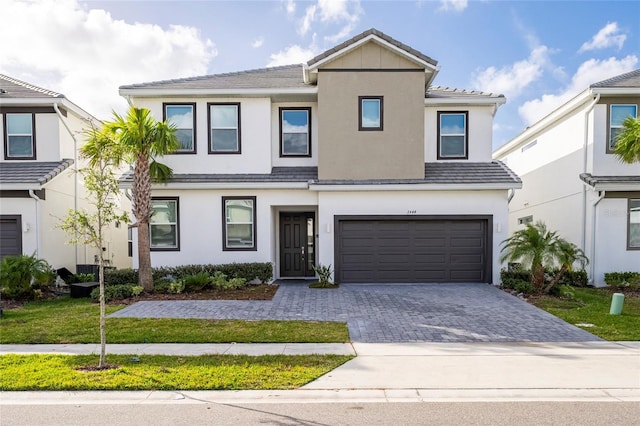 view of front of property with a garage and a front lawn