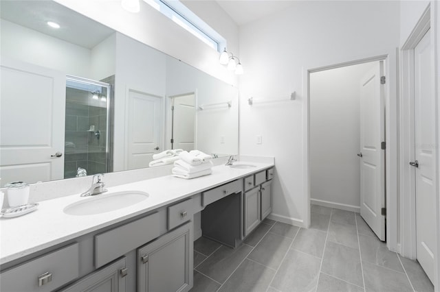 bathroom featuring tile patterned floors, vanity, and a shower with shower door