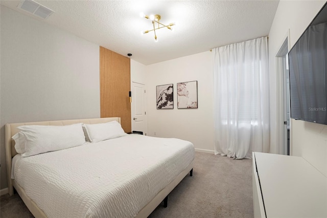 carpeted bedroom featuring a textured ceiling