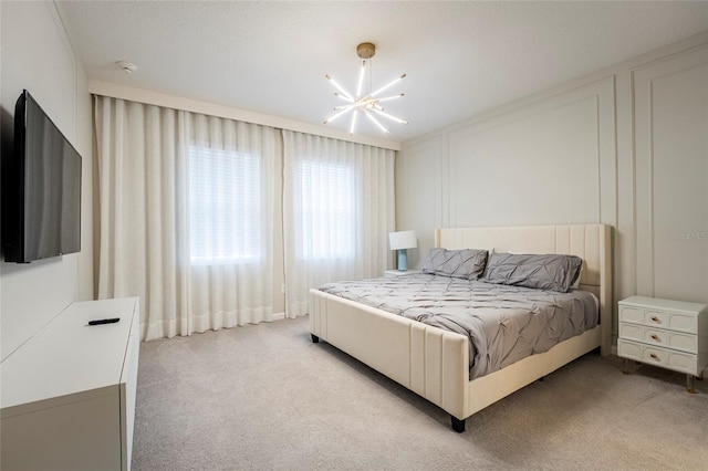 bedroom featuring a textured ceiling, light colored carpet, and a notable chandelier