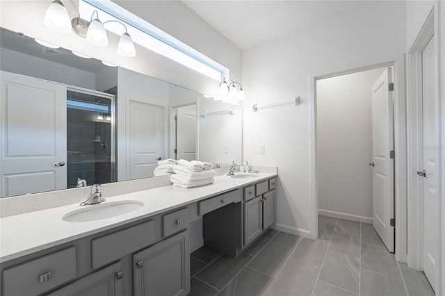 bathroom with tile patterned floors, vanity, and an enclosed shower